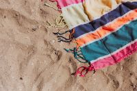 Colorful beach towel on the sand