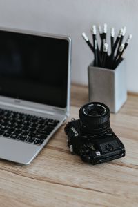 Kaboompics - Black-and-white photos with a silver laptop, pencils and a camera