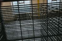 Kaboompics - A view through the grating in an abandoned building hall