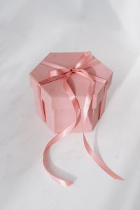 Kaboompics - Light pink velvety box with satin ribbon on white marble