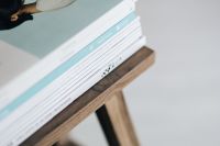 Kaboompics - Stack of magazines on the wooden stool