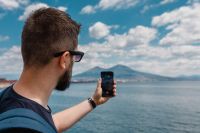 Kaboompics - A man taking a picture of the volcano Vesuvius with his mobile phone, Naples, Italy