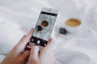 Kaboompics - Woman taking photo of coffee in bed