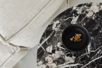 Marble side table - round - greige linen sofa - cement floor - jewelry - gold chain