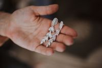 Kaboompics - Beautiful diamond earring on a hand