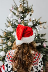 Kaboompics - Woman in Santa Hat, Christmas Tree Background