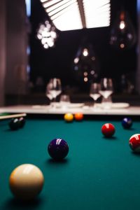 Kaboompics - Billiard balls on green table with billiard cue