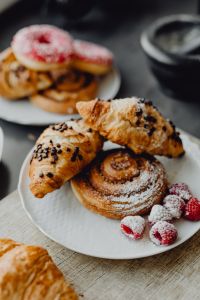 Croissants, puff pastry, powdered sugar and raspberries