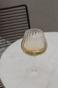 White Marble Table with a Glass of White Wine