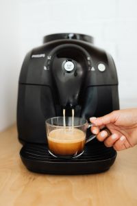 Kaboompics - The woman makes coffee with the machine