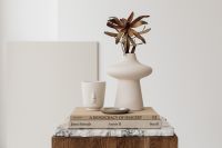 Kaboompics - Ceramic vase - side table - walnut wood - marble - books - dried flower