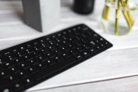 Kaboompics - Black keyboard with pencils on a white table