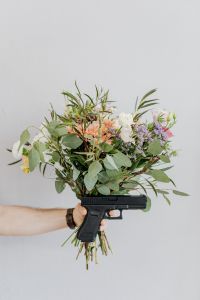 Kaboompics - A bouquet of flowers and a gun