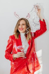 Kaboompics - Woman in a Red Jacket and Christmas Horns Celebrating New Year