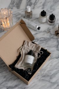 Kaboompics - Skincare Essentials Unboxing: Organic Serum in Eco-Friendly Packaging on a Marble Background
