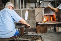Glassworker in action in the Murano glass factory