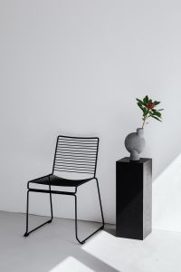 Kaboompics - Black metal chair - flowers - modern vase - pedestal