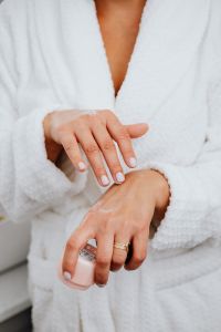Kaboompics - A middle-aged woman applying hand cream