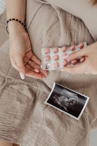 Pregnant Woman Taking Vitamin Pills - ultrasounds