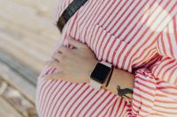 Kaboompics - A pregnant woman with a smartwatch on her hand