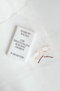 Book and glasses on white marble