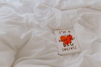 Kaboompics - A diary with red heart on the bed