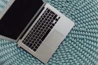 Kaboompics - MacBook Laptop on a blue pouf