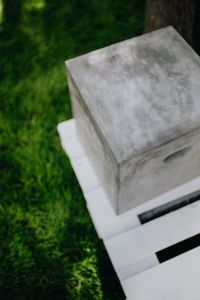Kaboompics - Concrete side table and green grass in garden