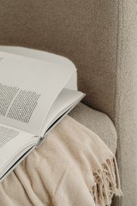 Home decorations - beige armchair - candles - book - blanket