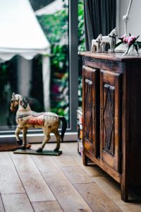 Vintage wooden furniture and horse sculptures