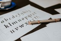 Alphabet on a paper with pencils