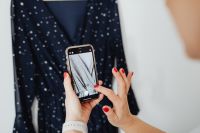 Woman takes photos of products she will sell online - dress