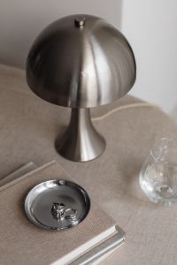 Kaboompics - Metal desk lamp - Silver Jewelry - Glass Of Water - Linen Tablecloth