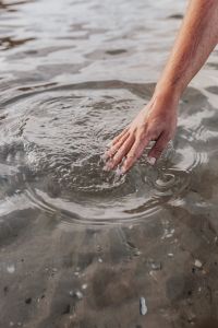 Kaboompics - Man hand touching sea surface