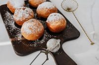 Kaboompics - Homemade doughnuts covered with powdered sugar. Traditional speciality on Fat Thursday in Poland.