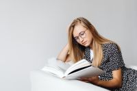 Kaboompics - A young girl is reading a book