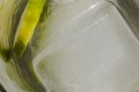 Kaboompics - Tall glass with water - lime - ice cubes - close up - closeup