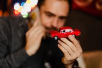 Kaboompics - A handsome man with Christmas presents - toy car