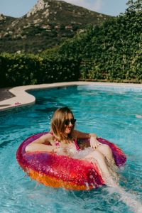 Kaboompics - A beautiful woman in a pool with an inflatable ring