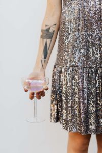 Kaboompics - Woman in a Sequin Dress is Holding a Glass of Champagne
