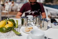 Kaboompics - Cups, silver jugs with coffee, Italian cookies and lemons on the table