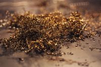 Close-ups of golden metal shavings on a table