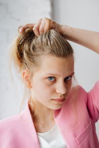 Kaboompics - Beautiful teenage girl with long blonde hair wearing a pink jacket
