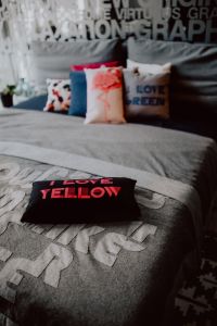 Kaboompics - Scandinavian decorative pillows on modern bed