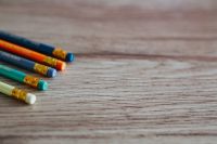 Kaboompics - Colourful pencils with rubber erasers on a wooden desk