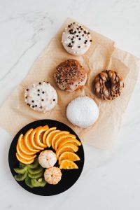 Kaboompics - Donuts, coffee & plate with fruits: orange, madarine, kiwi