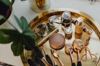Kaboompics - Makeup essentials on a golden tray