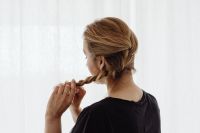 Kaboompics - A woman is doing a French braid