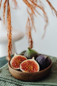 Kaboompics - A wooden bowl containing fresh figs