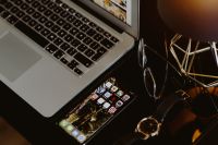 Elegant home office with golden accessories. MacBook, iPhone X, watch